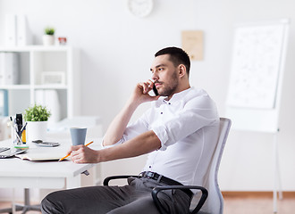 Image showing businessman calling on smartphone at office