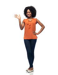 Image showing happy african woman waving hand over white