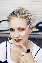 Image showing young pretty party girl smiling covered with glitter tinsel, fashion dress, stylish make up, lifestyle people concept close up