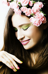 Image showing Beauty young real woman with pink flowers and make up closeup, s