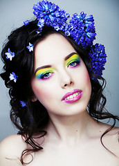 Image showing Beauty young woman with flowers and make up close up, real sprin