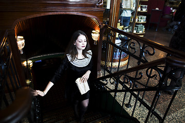 Image showing young elegant brunette woman in cafe drinking coffee, luxury int