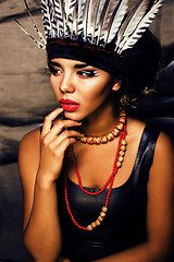 Image showing young pretty woman with make up like red indian, futher in hair,