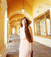 Image showing young pretty smiling woman in hat with bags on shopping at store