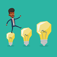 Image showing Businessman jumping on idea light bulbs.