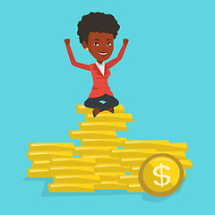 Image showing Happy business woman sitting on golden coins.