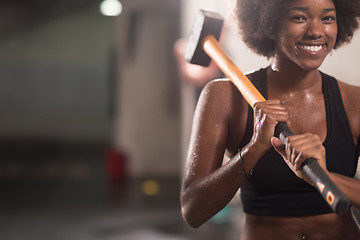 Image showing black woman after workout with hammer