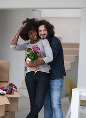 Image showing multiethnic couple moving into a new home