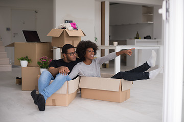 Image showing African American couple  playing with packing material