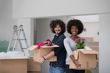 Image showing multiethnic couple moving into a new home