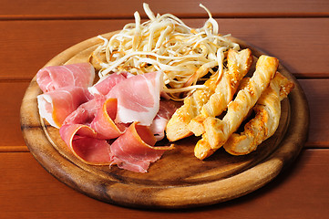 Image showing Beer snacks on wooden plate