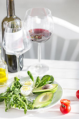 Image showing Wine, Tomatoes and greenery wooden background