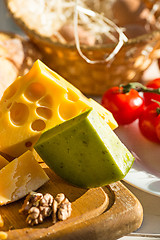 Image showing Wine, baguette and cheese on wooden background