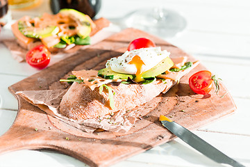 Image showing The baguette and cheese on wooden background