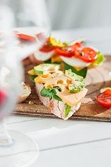 Image showing The baguette and cheese on wooden background