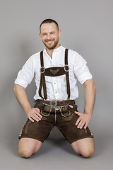 Image showing man in bavarian traditional lederhosen kneeling