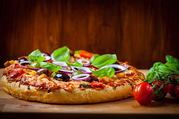 Image showing Traditional homemade pizza with tomatoes and olives