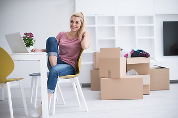 Image showing Young woman moving in a new home