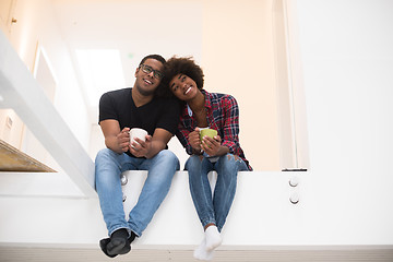 Image showing couple having break during moving to new house