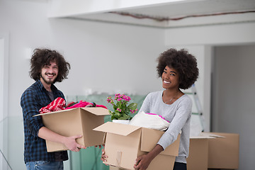 Image showing multiethnic couple moving into a new home