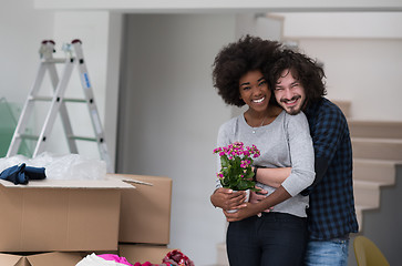 Image showing multiethnic couple moving into a new home