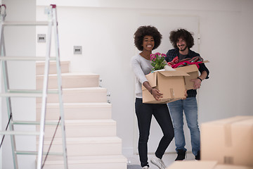 Image showing multiethnic couple moving into a new home