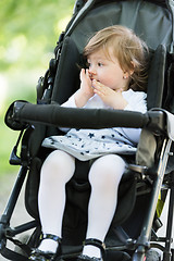 Image showing baby girl sitting in the pram