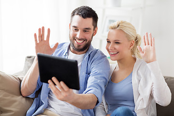 Image showing couple with tablet pc having video chat at home