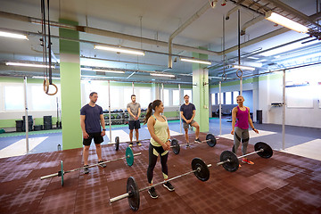 Image showing group of people training with barbells in gym