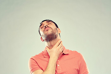 Image showing man touching neck and suffering from throat pain