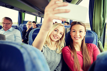 Image showing women taking selfie by smartphone in travel bus