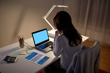 Image showing businesswoman with laptop at night office