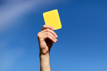 Image showing referee on football field showing yellow card