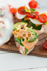 Image showing The baguette and cheese on wooden background