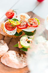 Image showing The baguette and cheese on wooden background