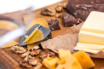 Image showing The different kind of cheese and walnuts on wooden background