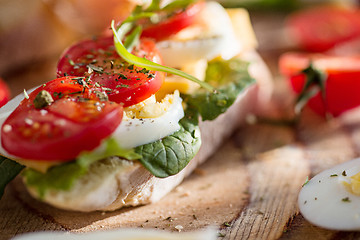 Image showing The baguette and cheese on wooden background