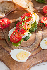 Image showing The baguette and cheese on wooden background