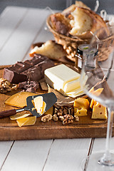 Image showing The different kind of cheese and walnuts on wooden background