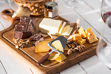 Image showing The different kind of cheese and walnuts on wooden background