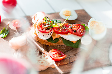 Image showing The baguette and cheese on wooden background