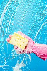 Image showing Person cleans glass with sponge