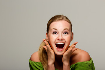 Image showing Surprised model in green sweater