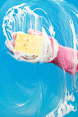 Image showing Man with glove cleaning window