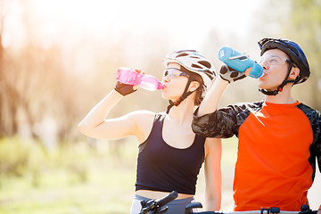 Image showing Cyclists drink water from bottle