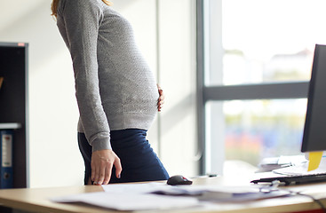Image showing pregnant businesswoman with computer at office