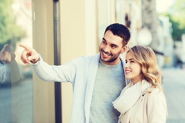 Image showing happy couple shopping and looking at shop window