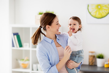 Image showing happy mother and little baby girl at home kitchen