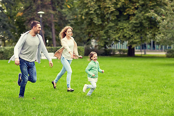 Image showing happy family walking in summer park