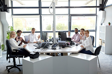 Image showing business team waving hands at office